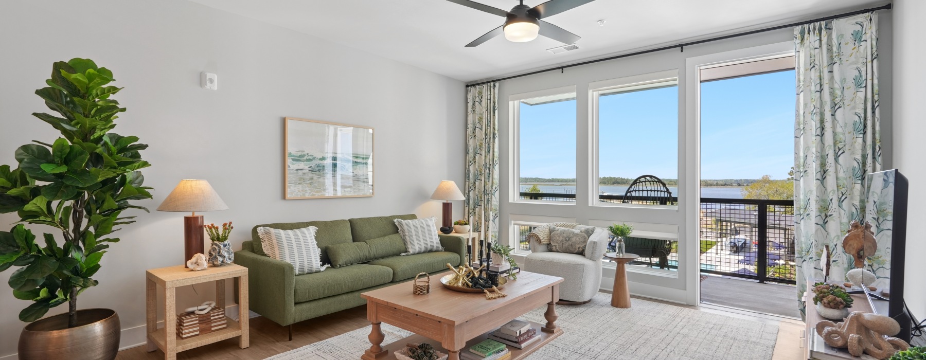 a living room with couch and a window with water view